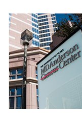 Photograph of hospital building with MDAnderson Cancer Center sign near the top.