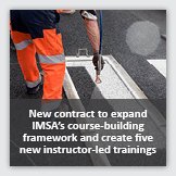 News 1: Square photograph of roadway marking technician painting a cross walk, overlayed with foreground text reading New contract to expand IMSA's course-building framework and create five new instructor-led trainings.