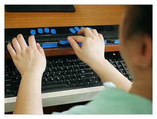 Blind woman using braille keyboard to take elearning course on computer