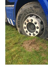 Photograph of truck stuck in mud rut and unable to move