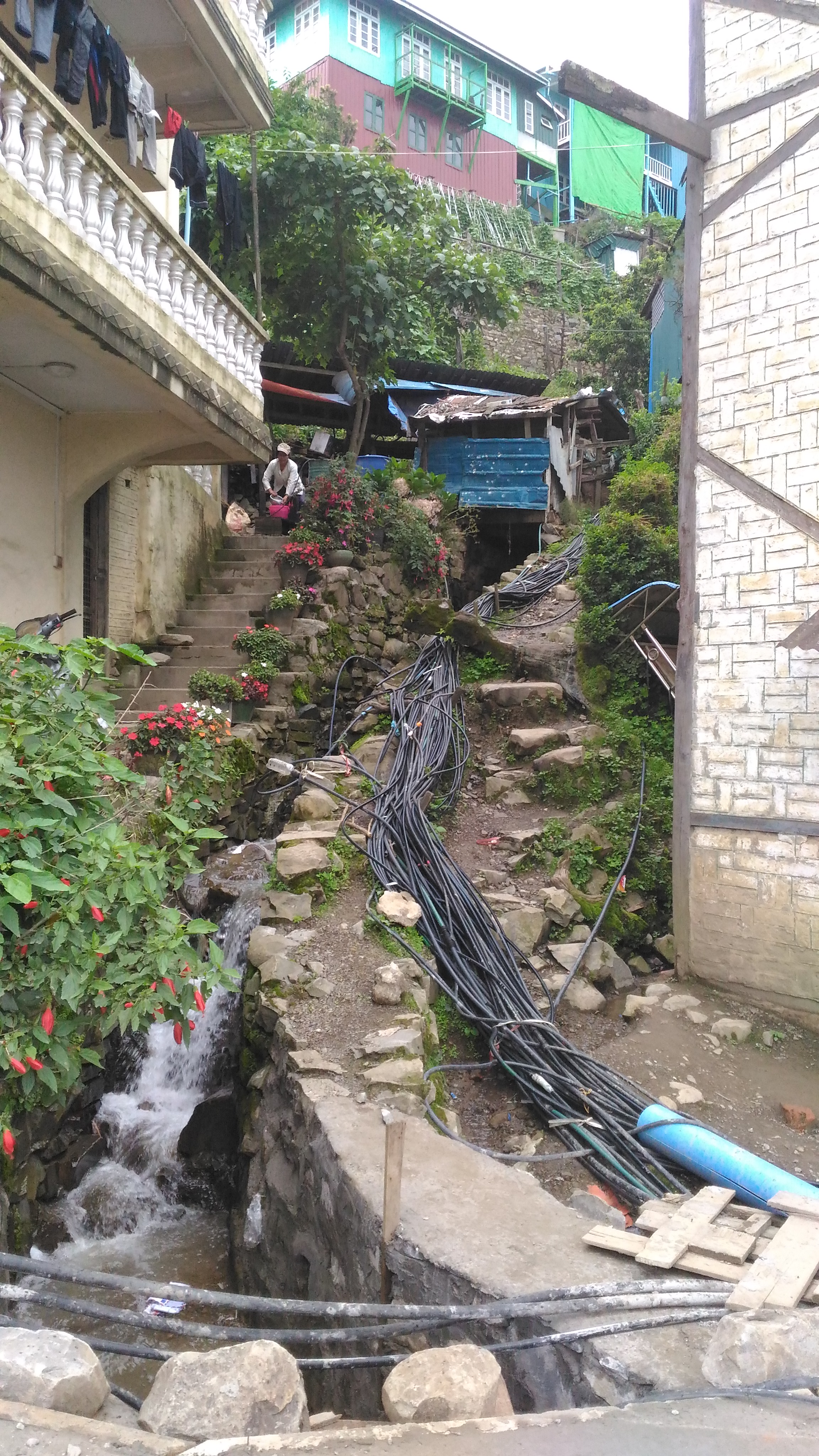 Tens of exposed and entangled pipes distribute water to individual houses 