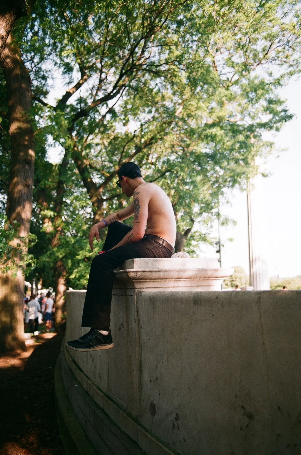 Unknown man lounging in the wooded section of Grant Park listening to music. Chicago Blues Festival 2016, Blake Pleasant
