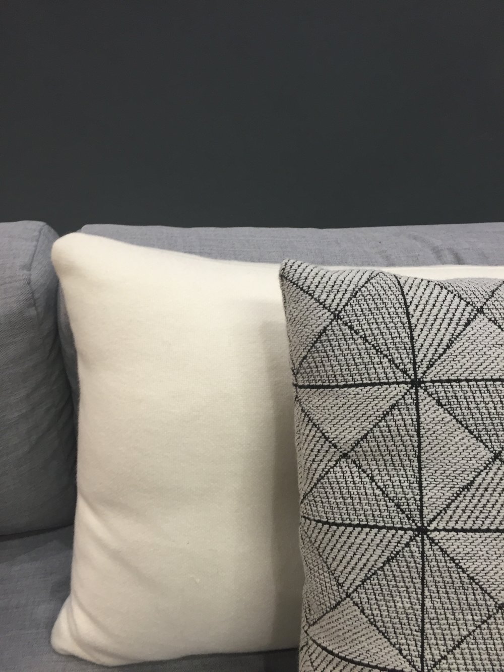 A close up of the Hay Dot cushion and Muuto Tile cushion. 