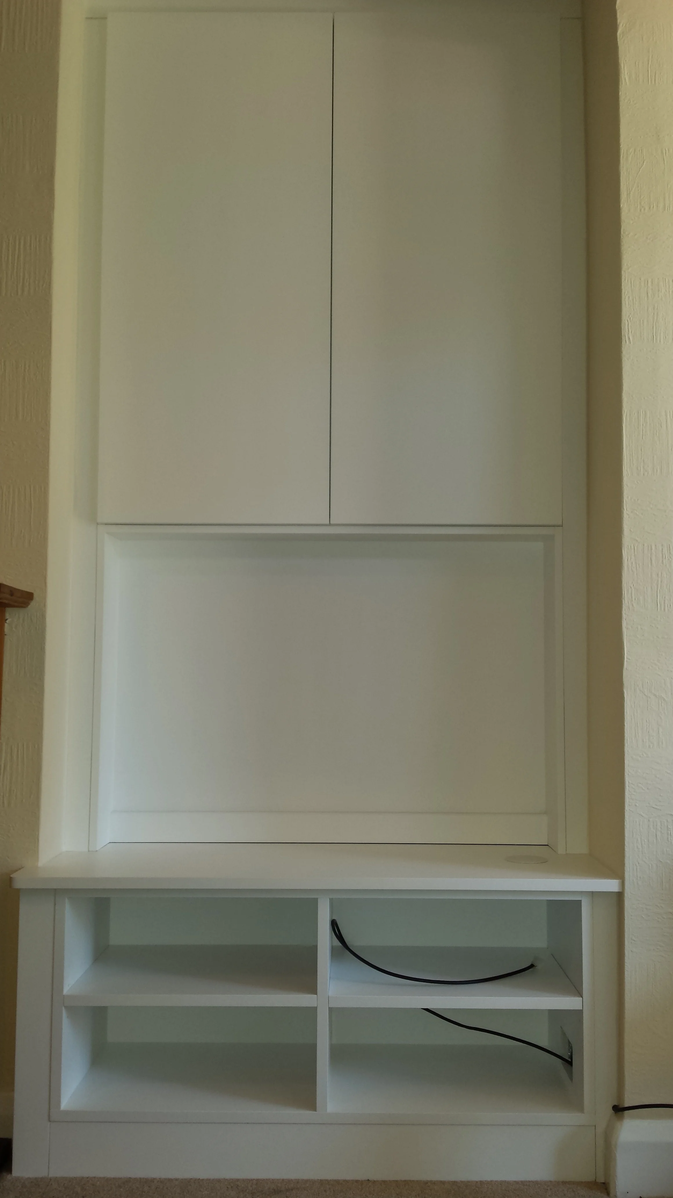 TV enclosure with cupboards above