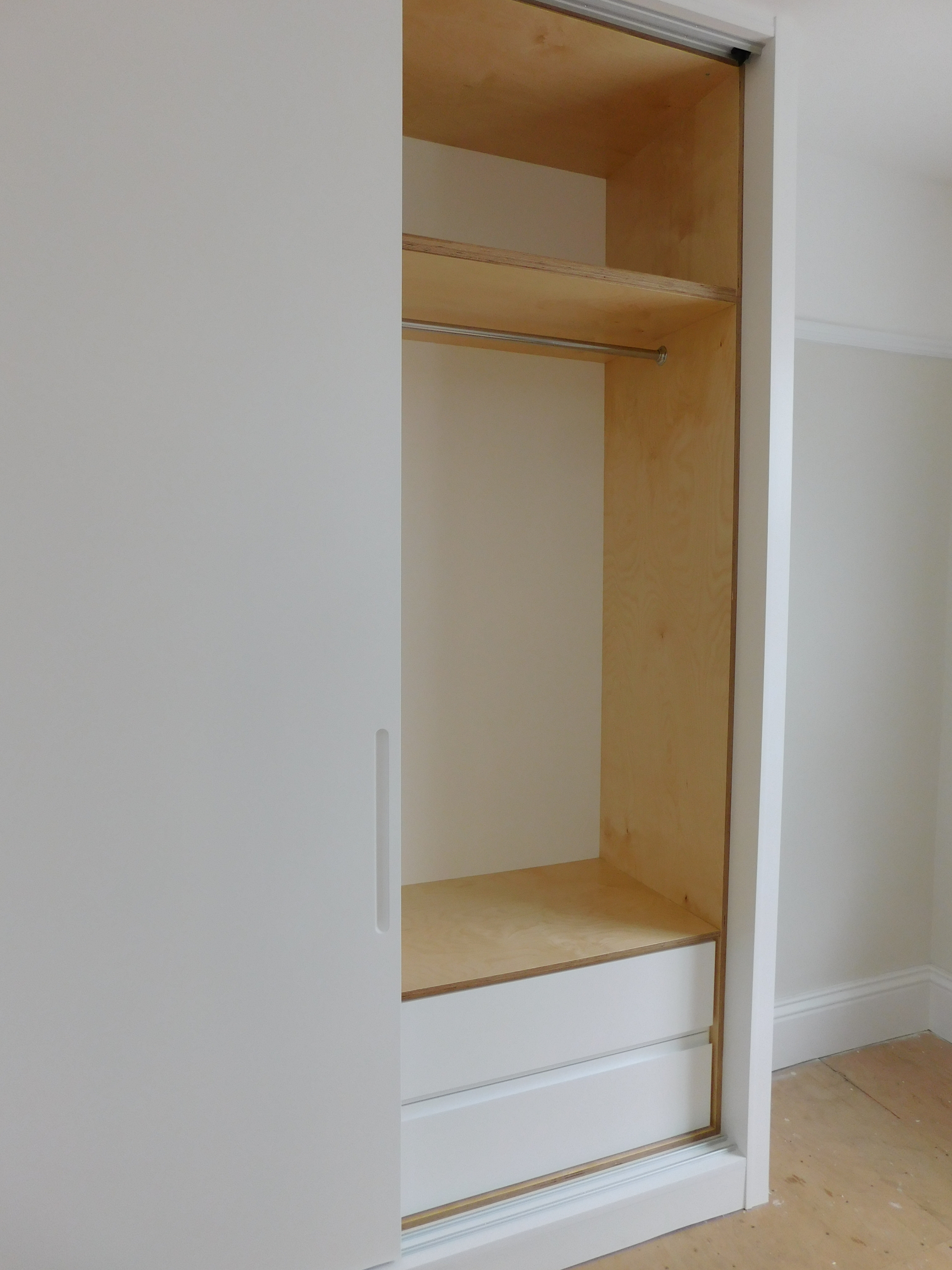 Drawer set behind sliding doors