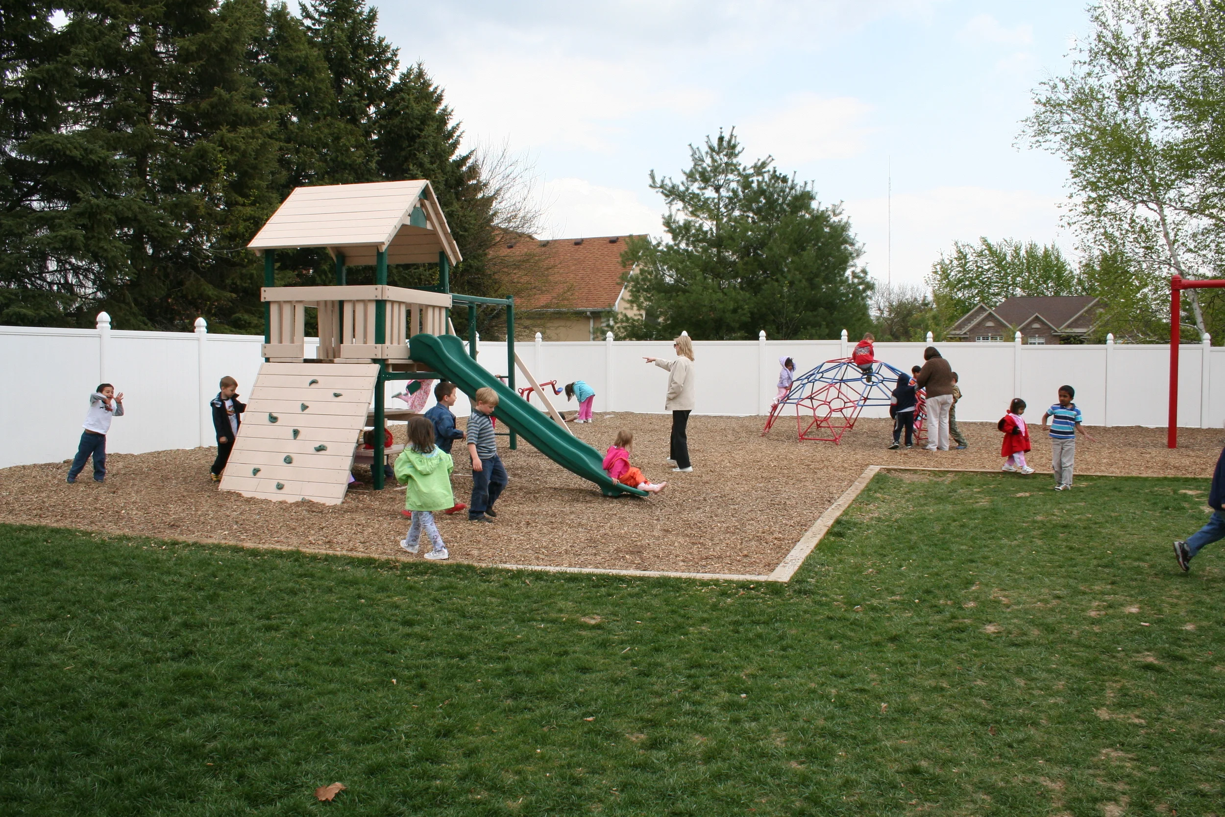 Children learning near the greenhouse at International Montessori School