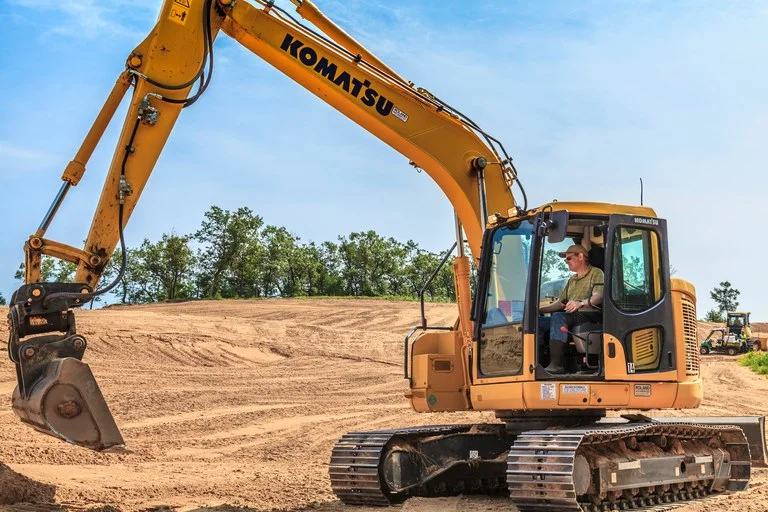 Brian Silvernail takes the driver's seat in an excavator (photo by Ryan Farrow)