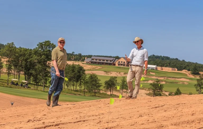 Brian Silvernail and David McLay Kidd flag a fairway edge. ( Photo by Ryan Farrow)