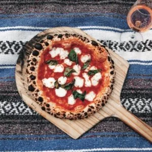 TWO DOUGHS PIZZA Naturally leavened Neopolitan pizza comes with a full pizza pop-up kitchen experience. A wood burning oven fired with almond and white oak is accompanied w/ professional pizza makers curating specialty pizzas from start to finish for your party.