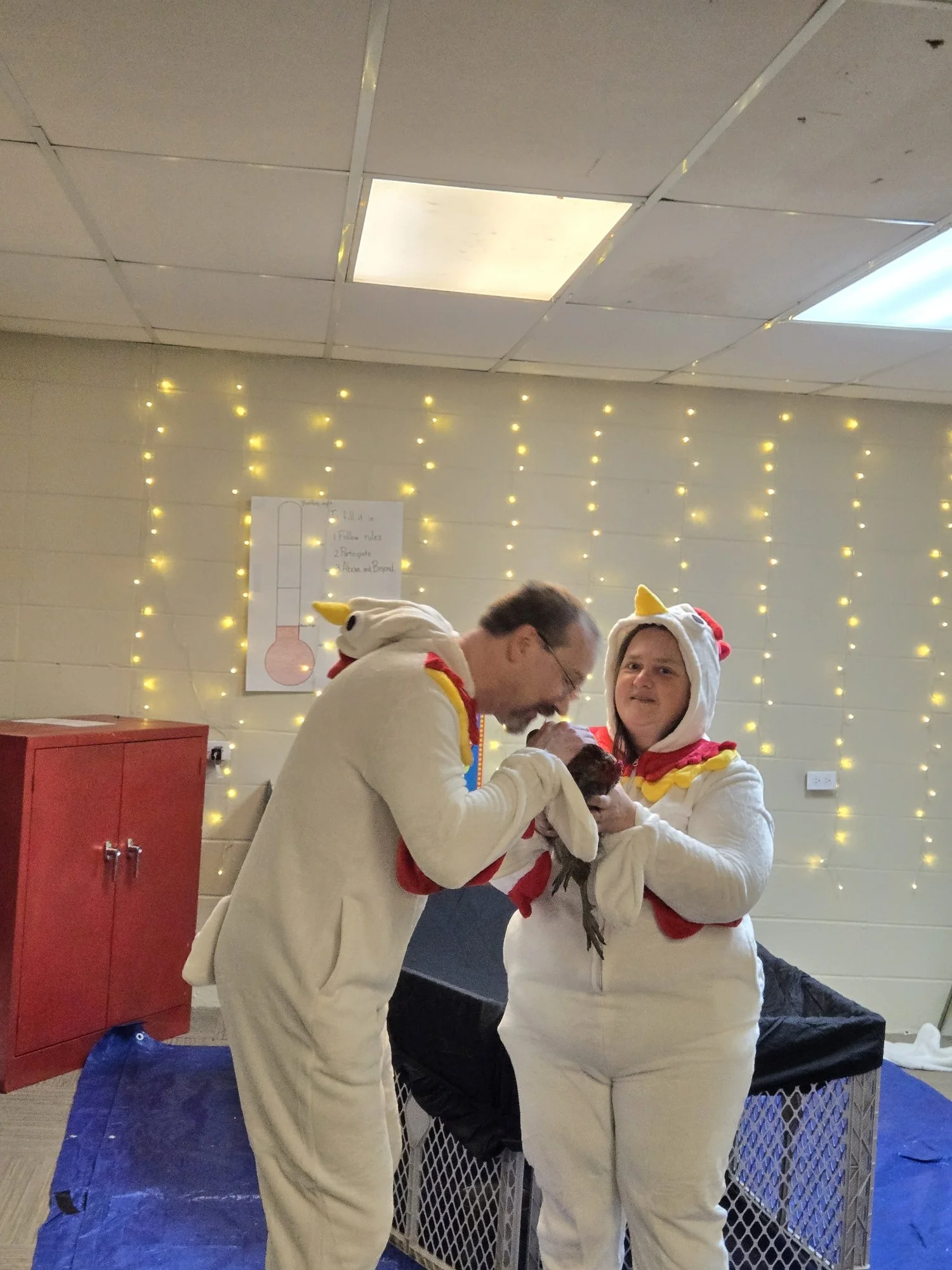  2026 Missions Convention—Pastors Allen and Kristy Moore kiss a chicken 