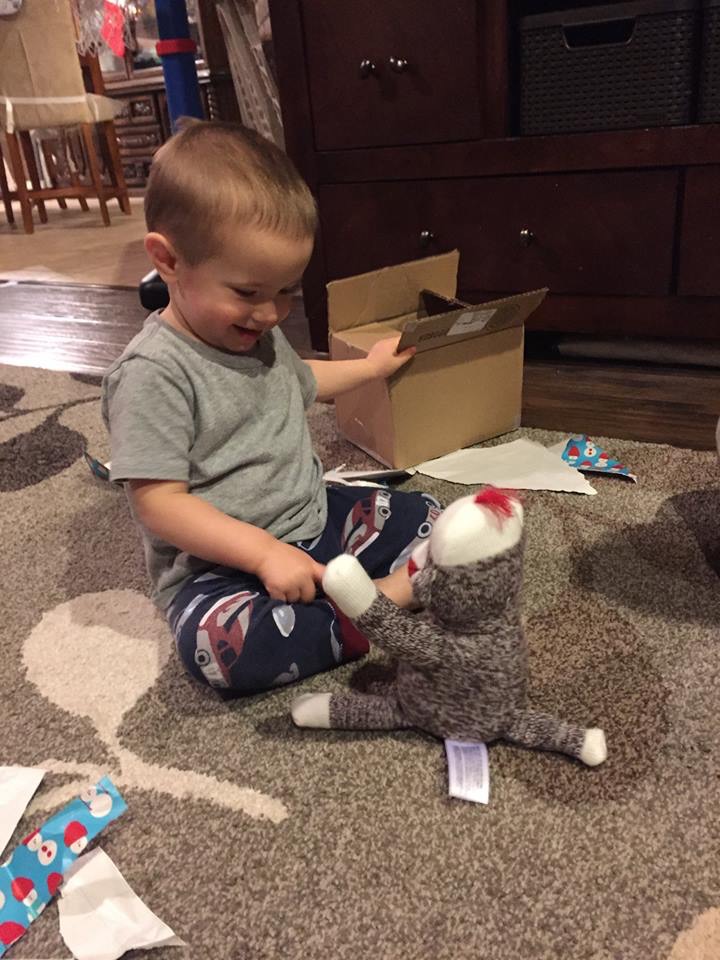 Opening his sock monkey from his Virginia family.