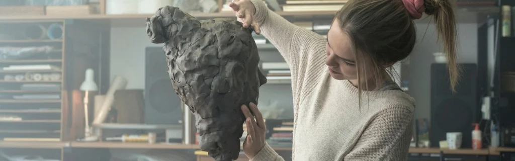 young-sculptor-creates-a-clay-sculpture-picture-id678969546.jpg