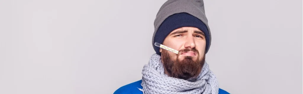 young-adult-bearded-man-have-temperature-holding-thermometer-in-mouth-picture-id885311386.jpg