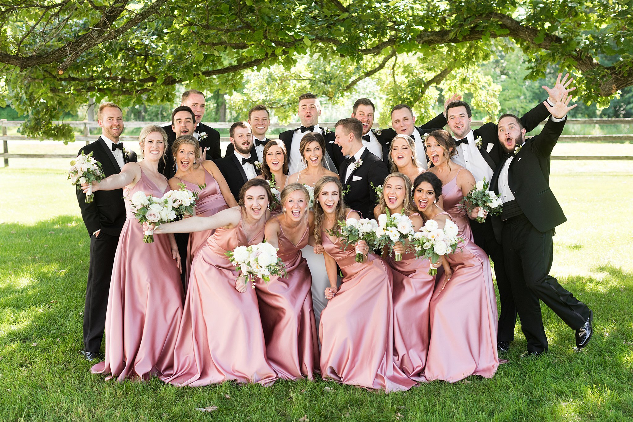  Bride and groom posing with bridal party at Mayowood Stone Barn. 