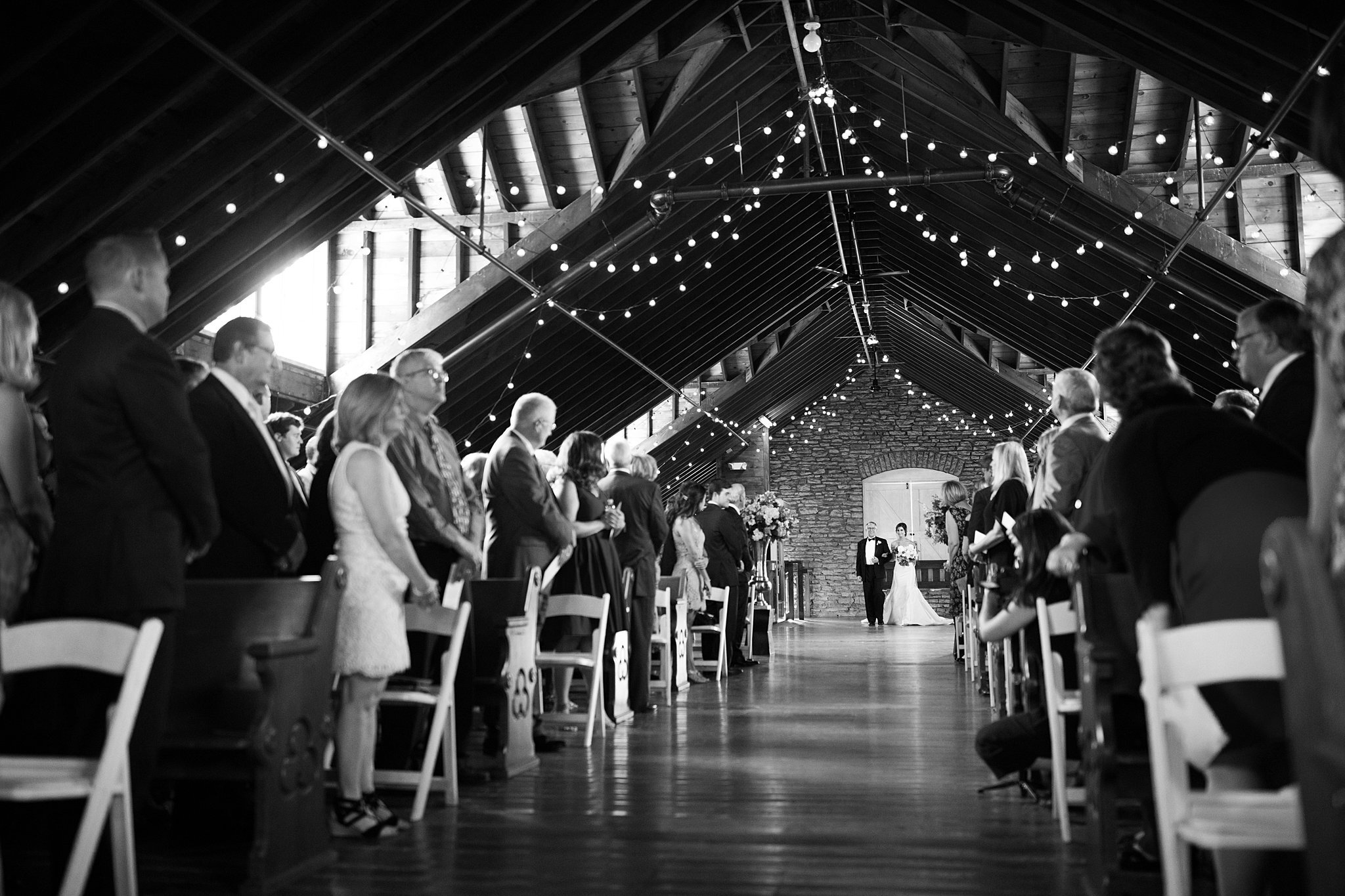  Bride and her father walk down aisle at Mayowood Stone Barn. 