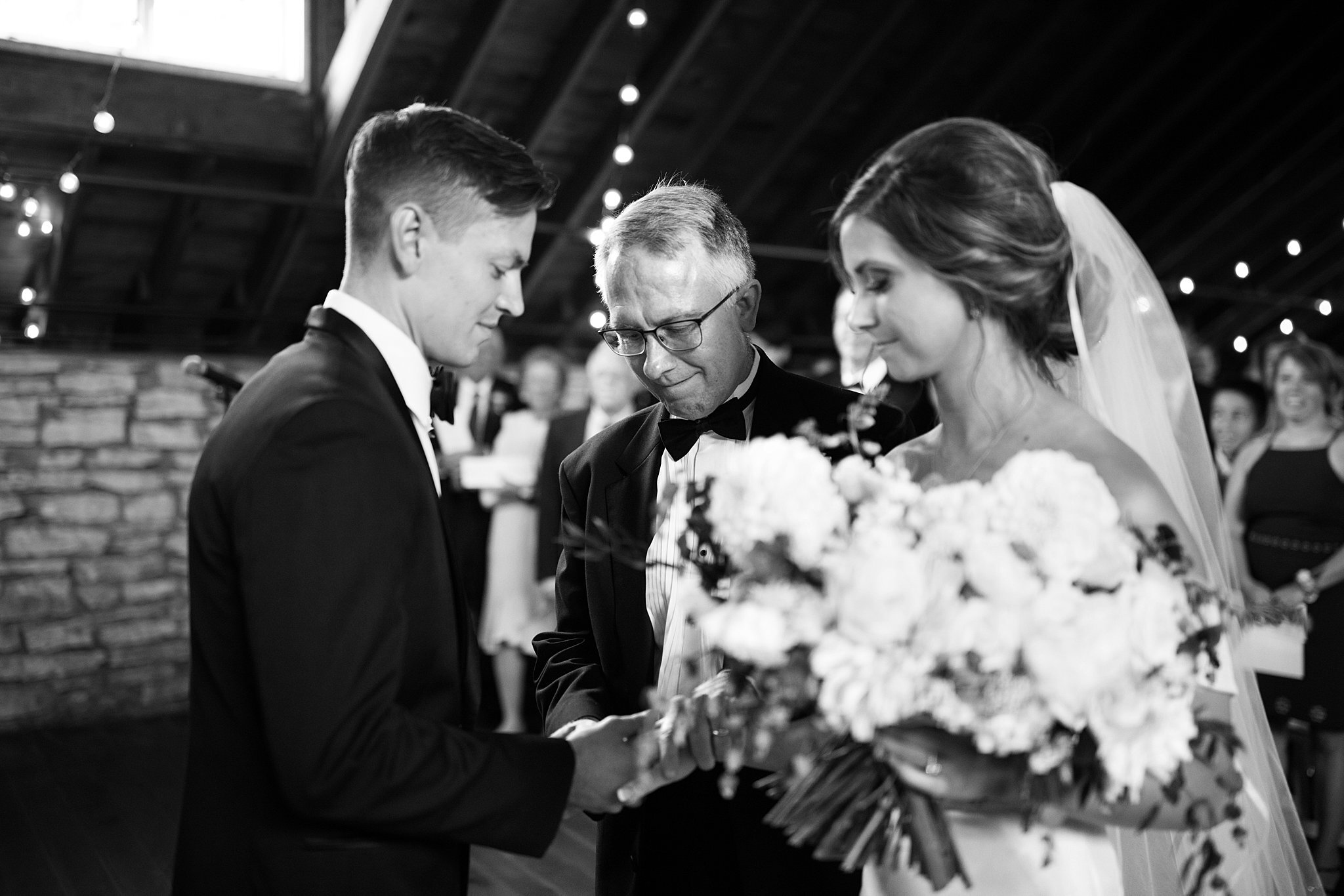  Father transfers daughter's hand to groom's hand. 