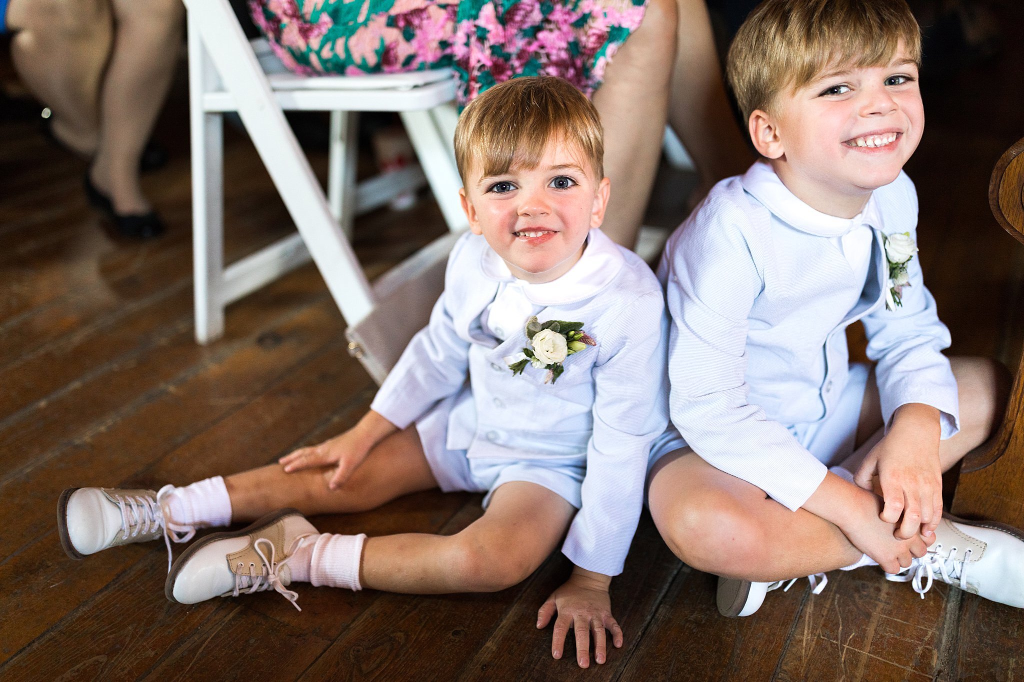  Ring bearers sitting on floor watching ceremony. 