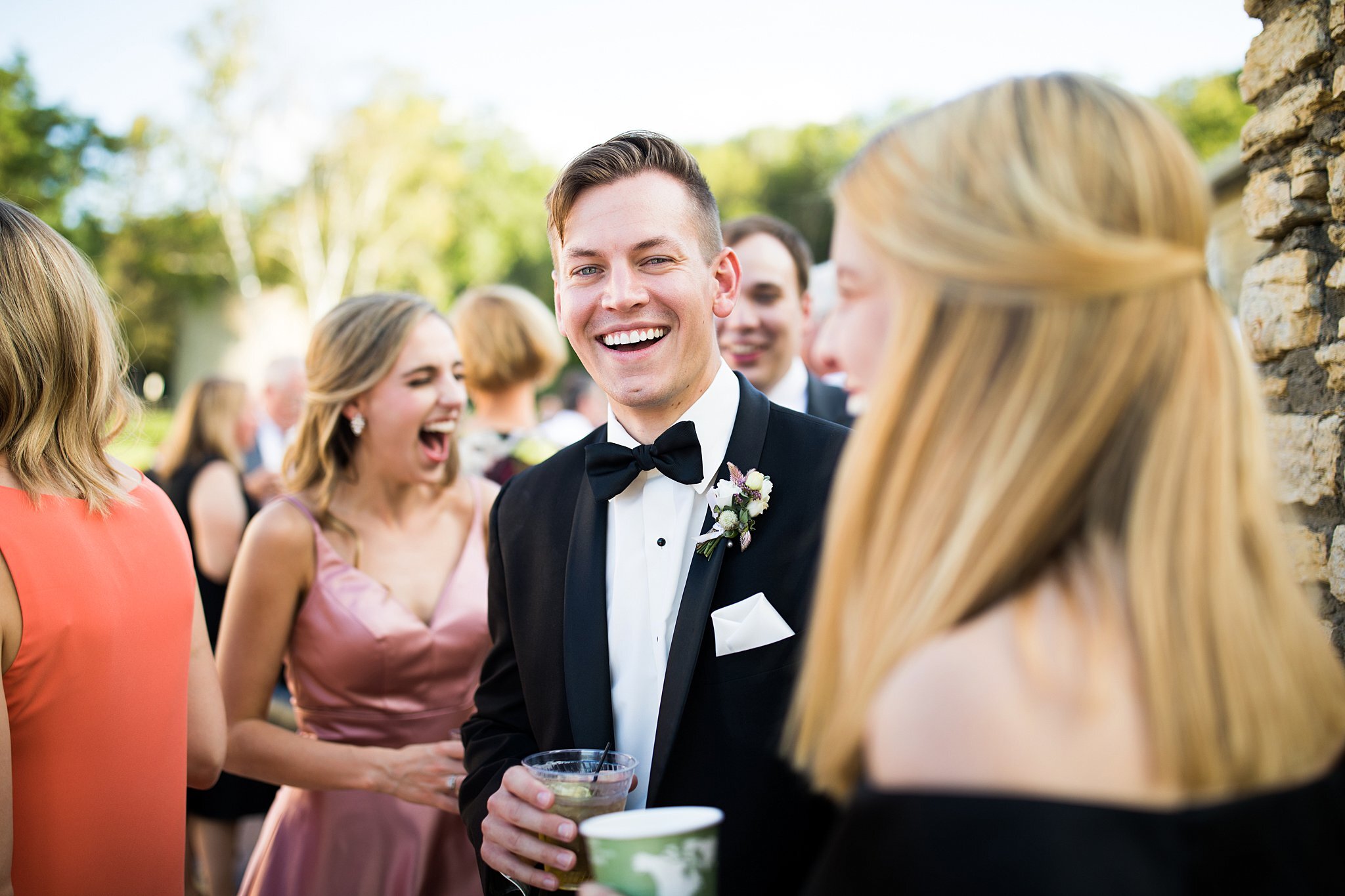  Groom enjoying cocktail hour at Mayowood Stone Barn 1 of 2. 