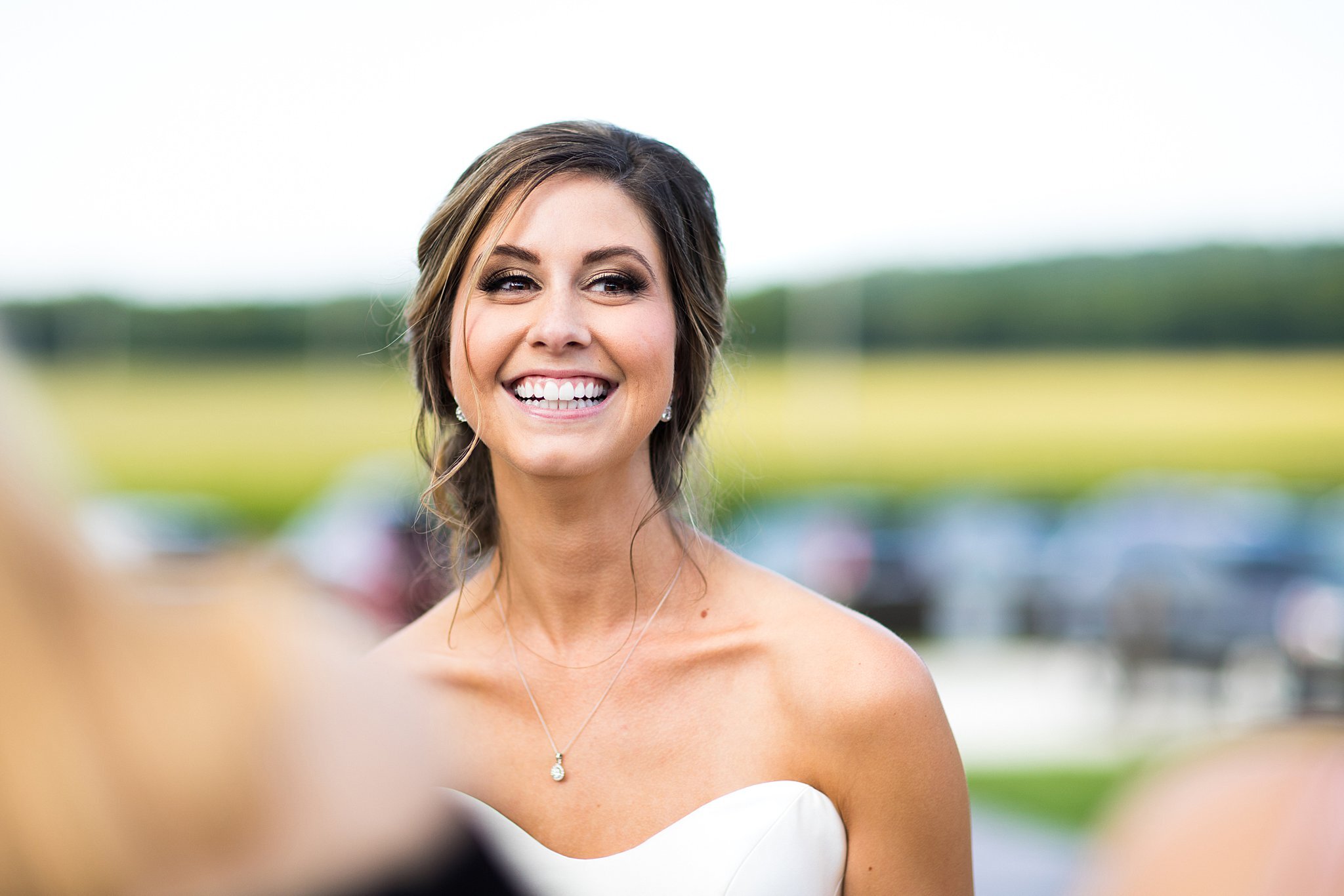  Portrait of bride smiling outside Mayowood Stone Barn. 