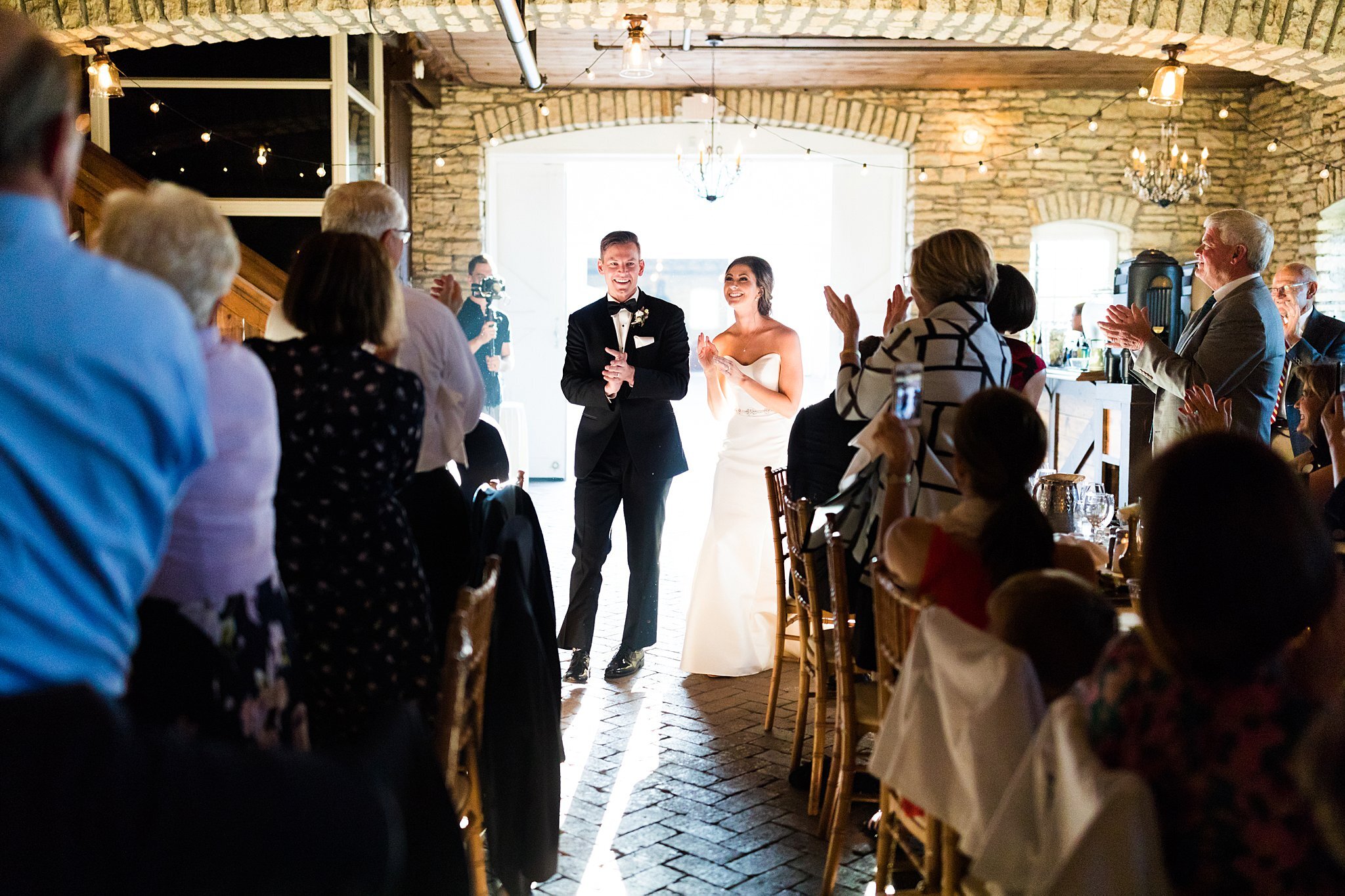  Guests welcoming bride and groom to wedding reception at Mayowood Stone Barn. 