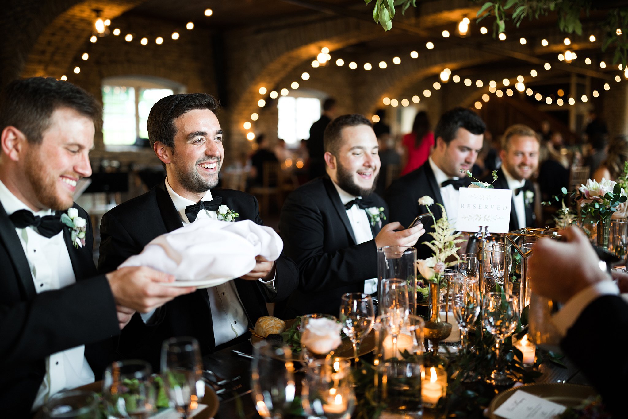  Groomsmen at head table passing a plate of bread. 
