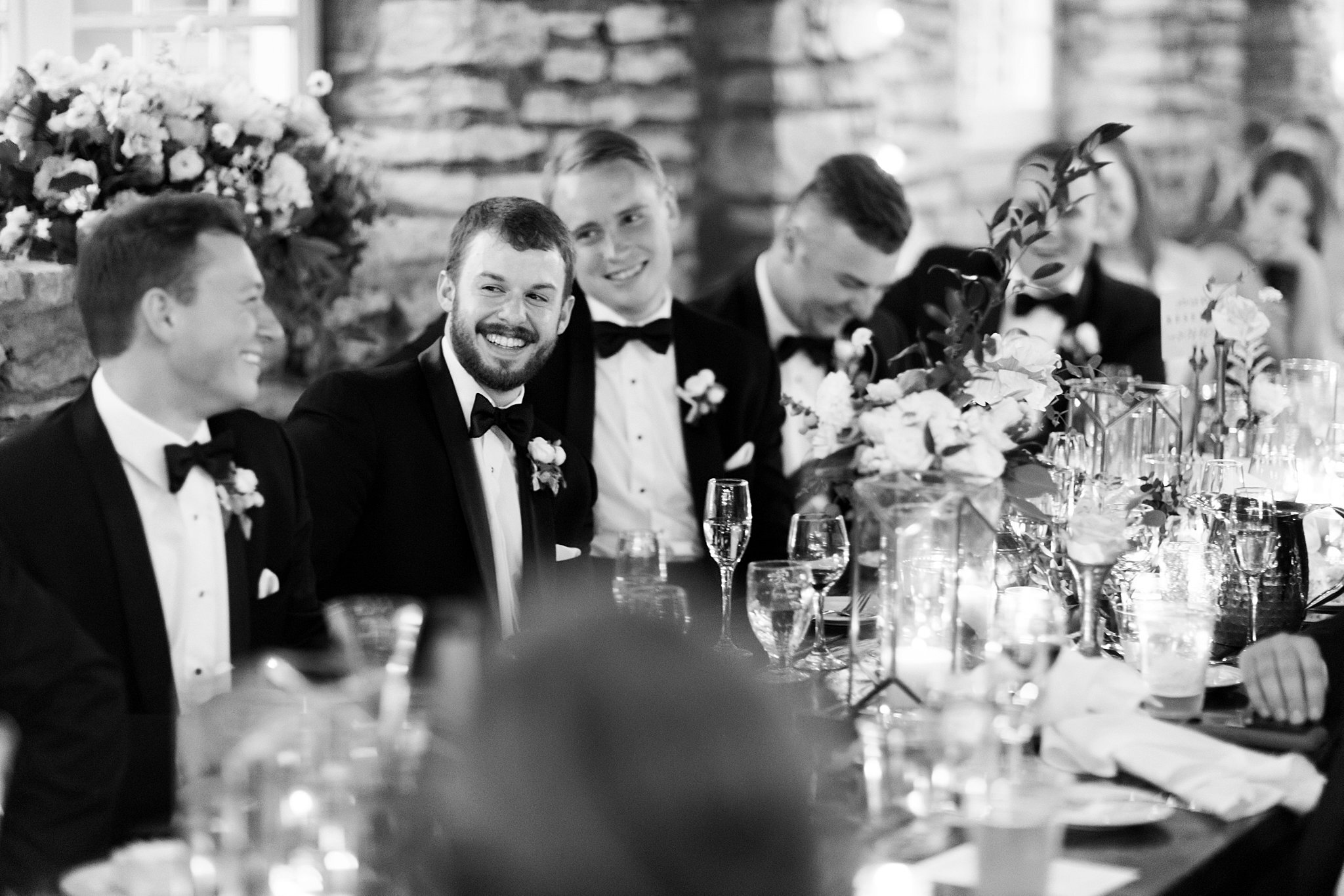 Groomsmen sharing a laugh at the head table. 