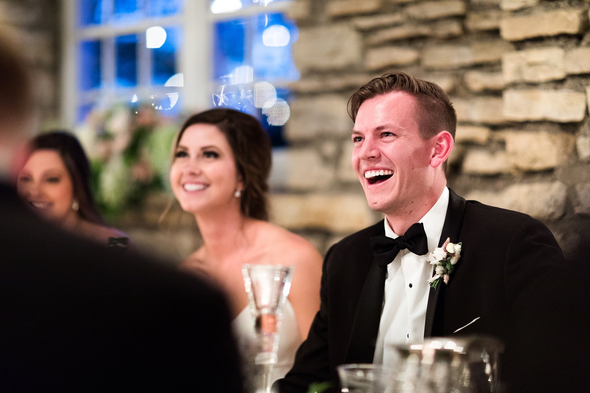  Groom laughing and tearing up during best man speech. 