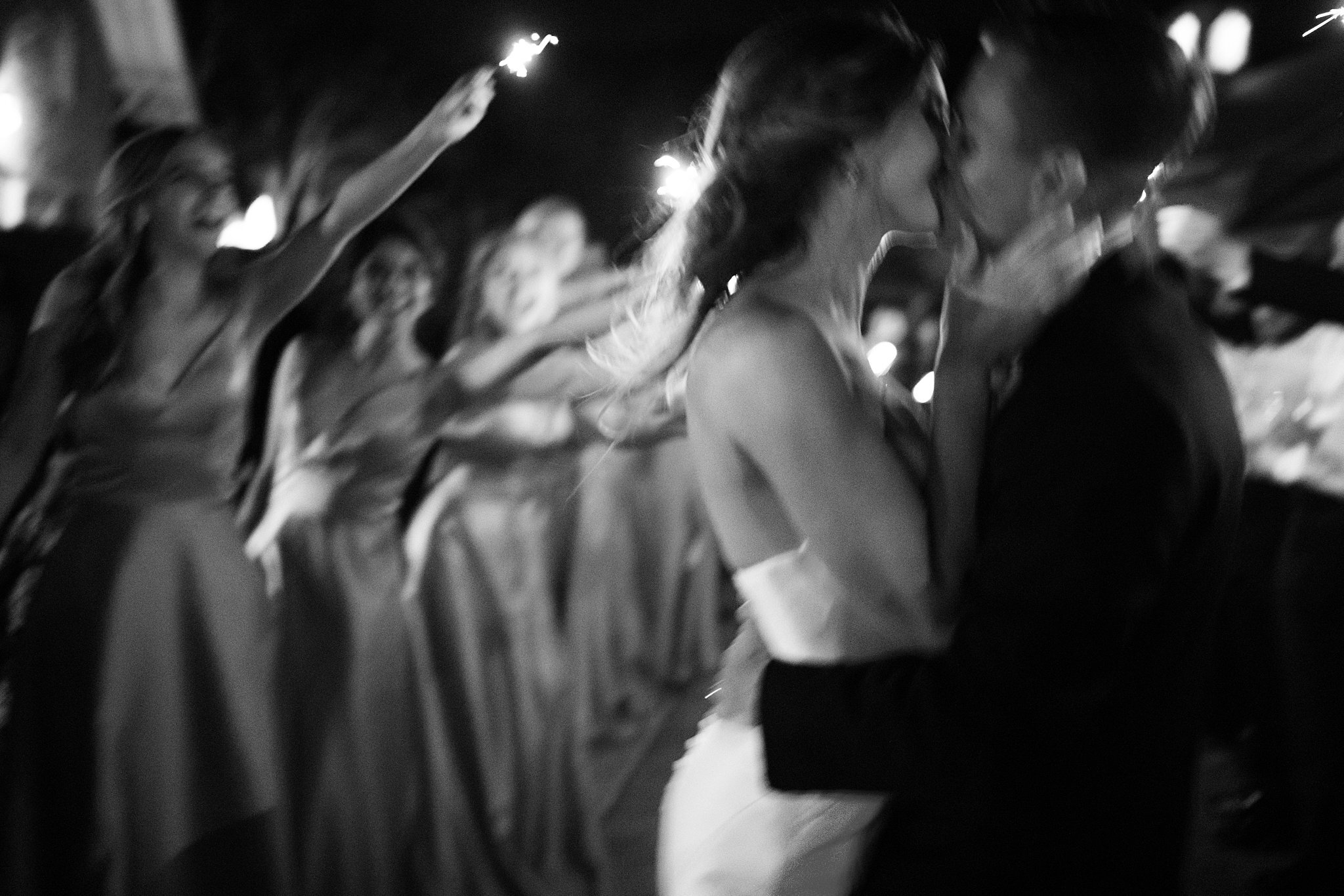  Bride and groom kissing during sparkler send off at Mayowood Stone Barn. 