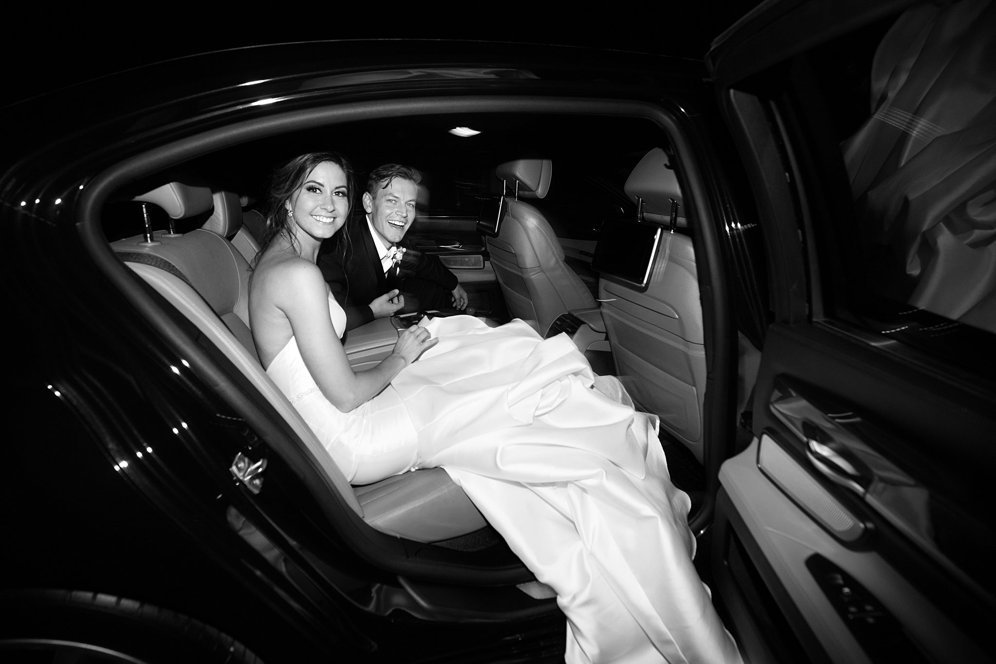  Bride and groom sitting in car departing Mayowood Stone Barn. 