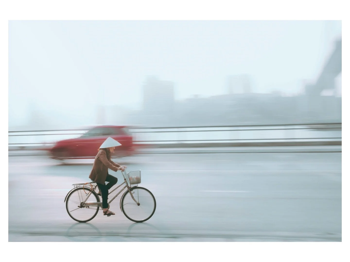 Rush hour, two wheels! Caught this near Bai Chay Bridge, Ha Long Bay, Vietnam. 

📷 @fujifilmx_us 
🎨 @Lightroom
&copy; Wes Marsala 2025

👆🏻hit the follow for more

#HaLongBay #BaiChayBridge #VietnamTravel #ConicalHat #RushHour #CyclingLife #Vietna