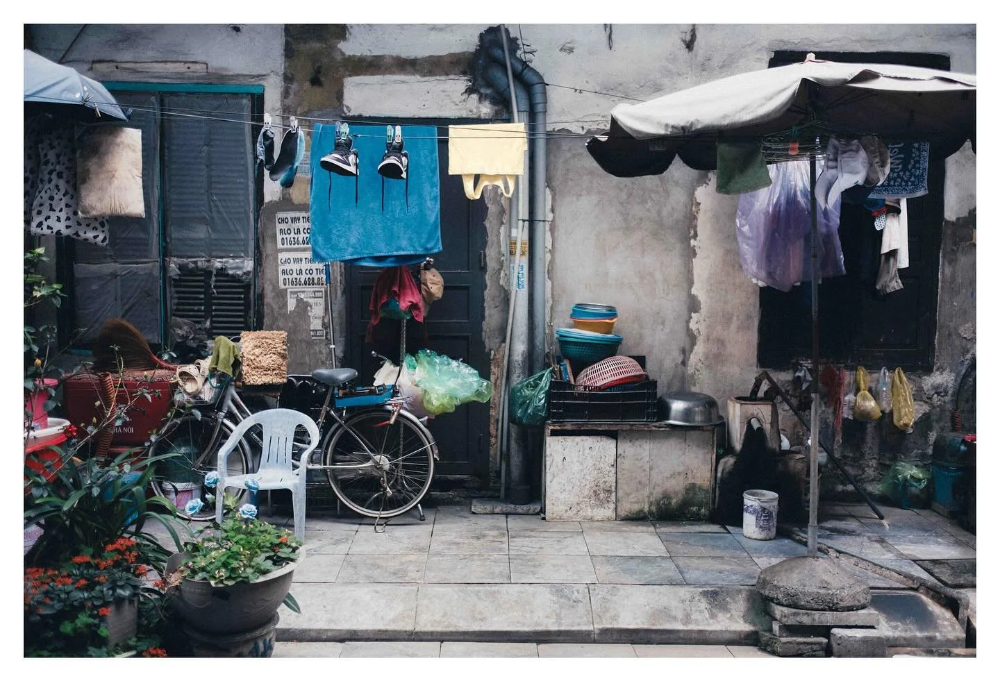 Every doorway in Vietnam wears its own personality&mdash;boots guarding one, bright laundry framing another, a rust-scarred bike standing watch like a loyal old friend. Small scenes and quiet stories most will never see. 

📷 @fujifilmx_us/23mm 1.4
?