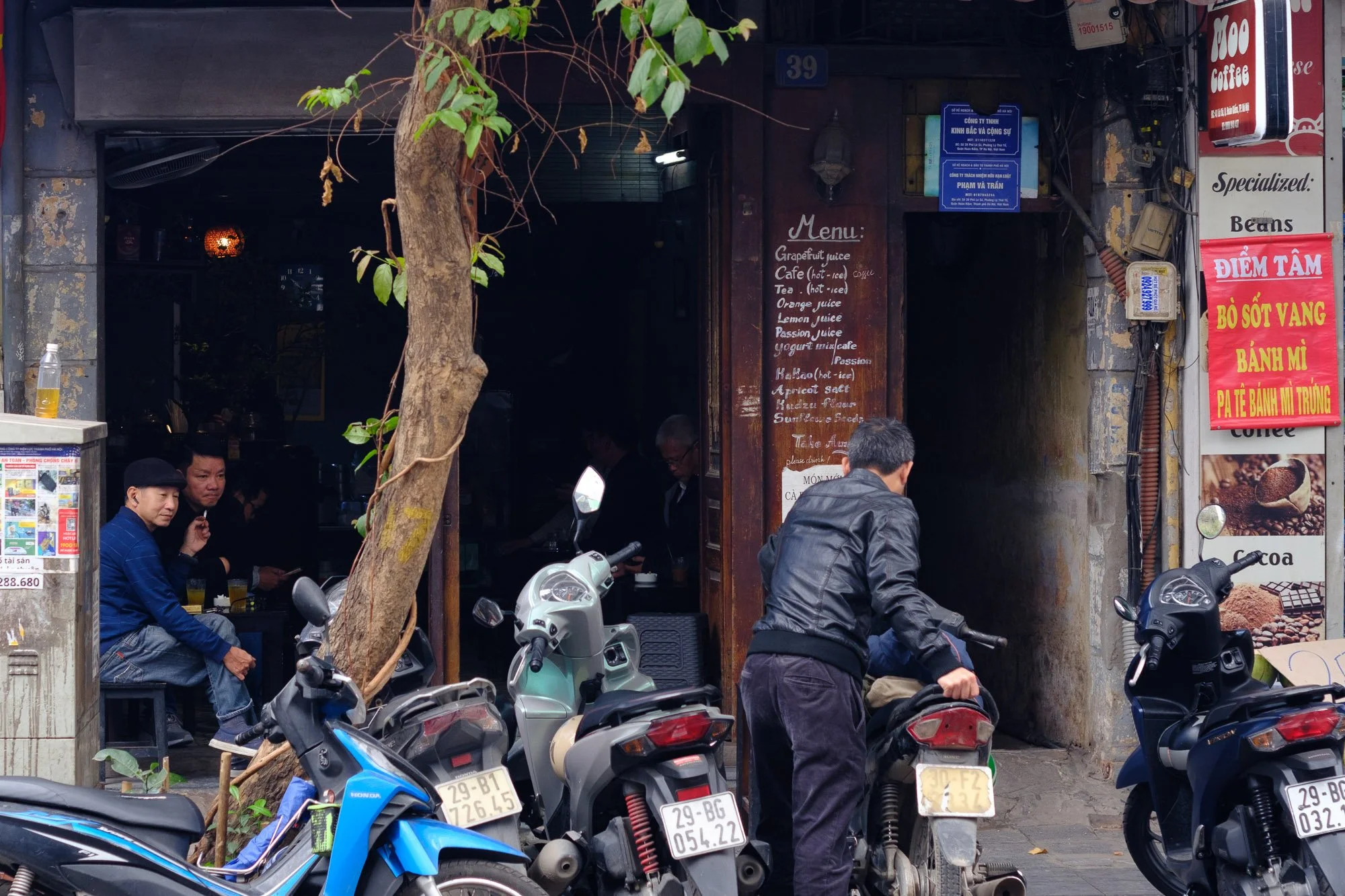 A man smoking a cigarette at the cafe.