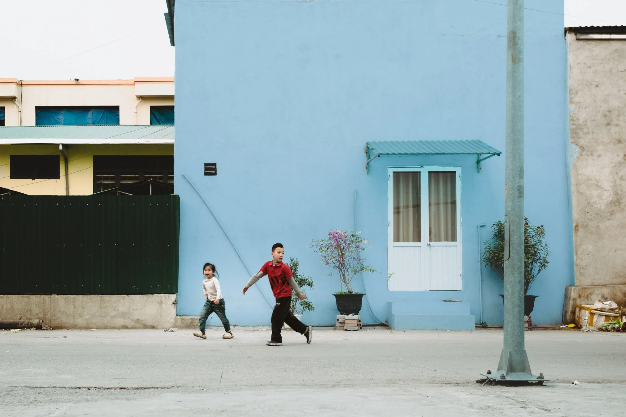 A boy and girl playing outside, Hon Gai, Vietnam