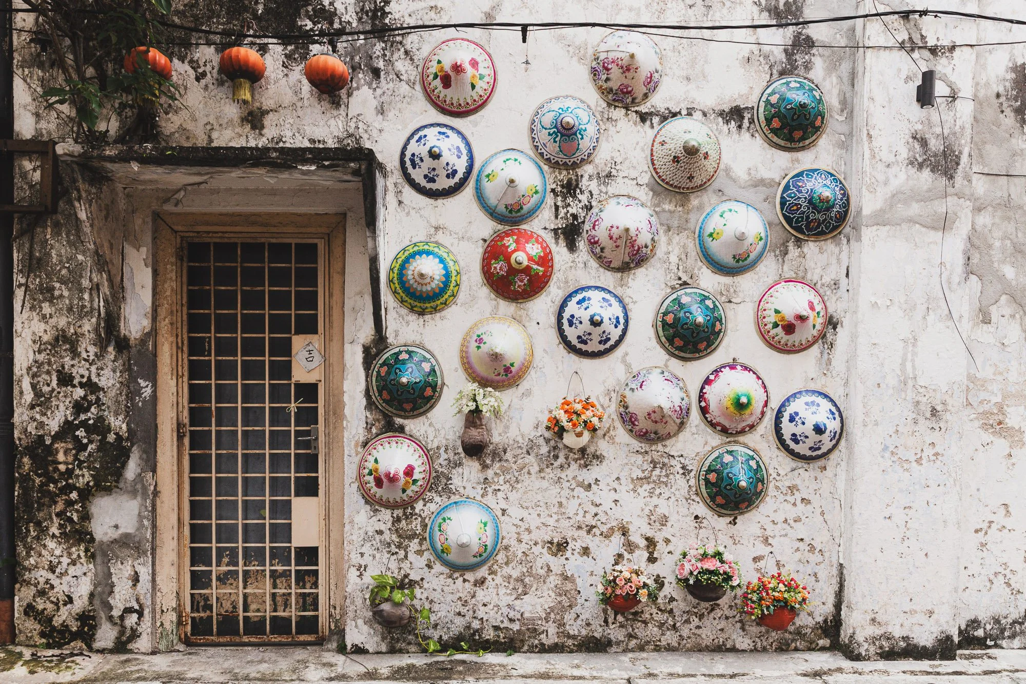 Colorful hats on a wall in an Alleyway in Ipoh, Malaysia