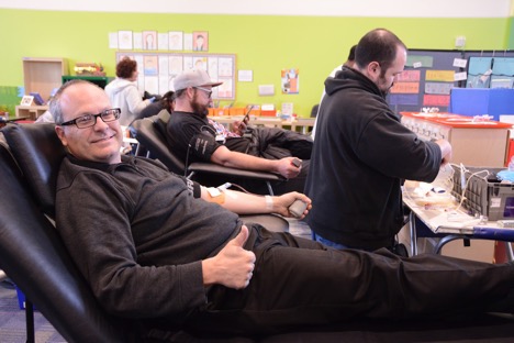 Acting Head of School Dave Lessing shows the kids he's not scared of needles.