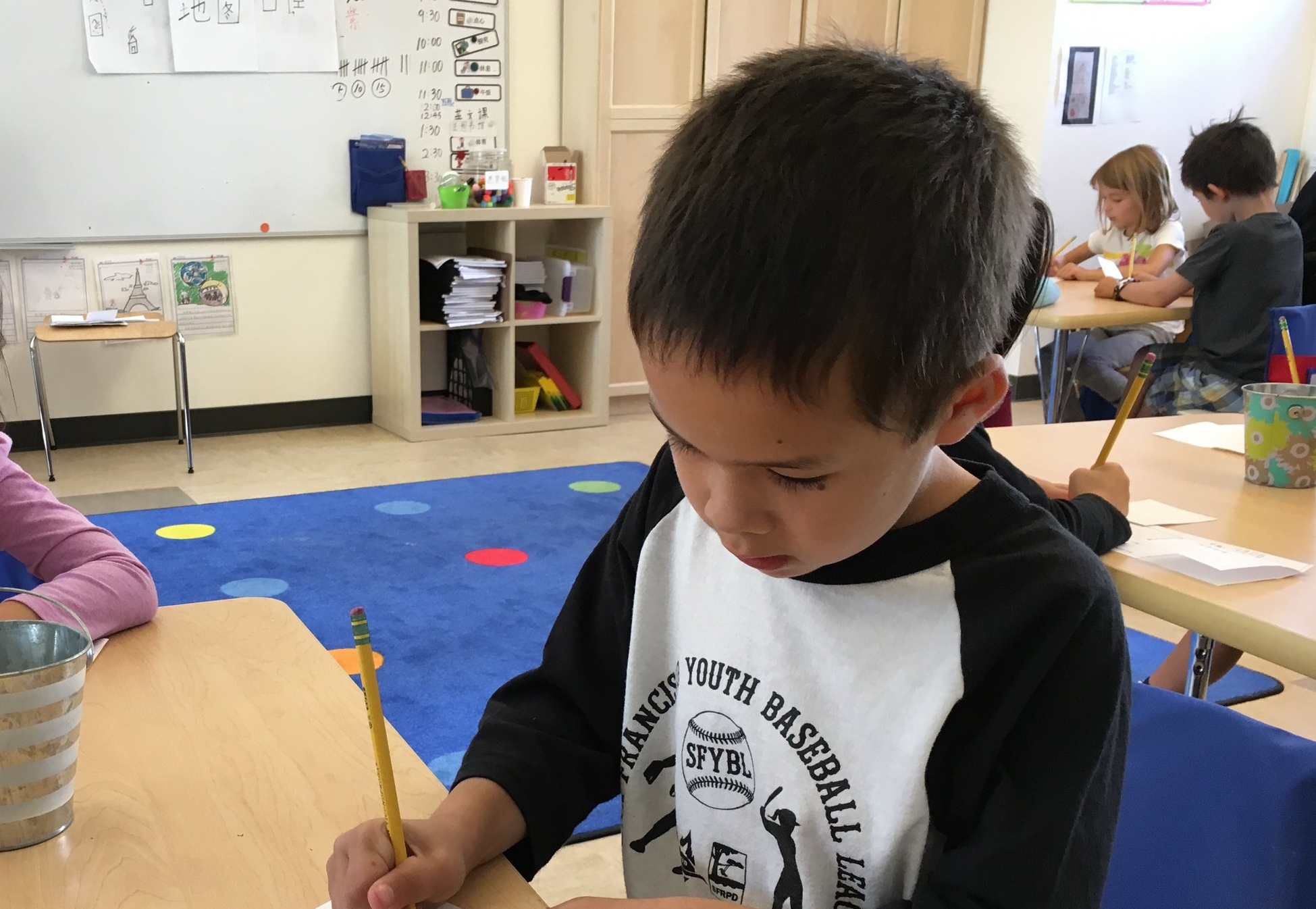 A first grader works on his creative project.