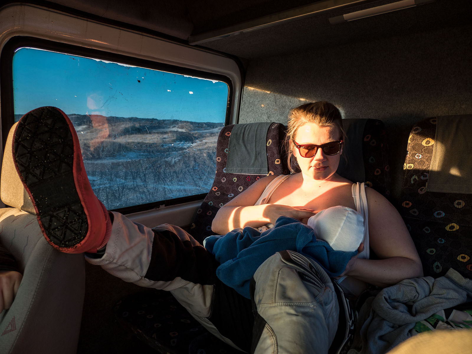 Guðný gives one month old Úlvur a feed before getting on her motorcycle to ride in Sandvík, Iceland with her husband Jói who is training for the Abu Dhabi Desert Challenge