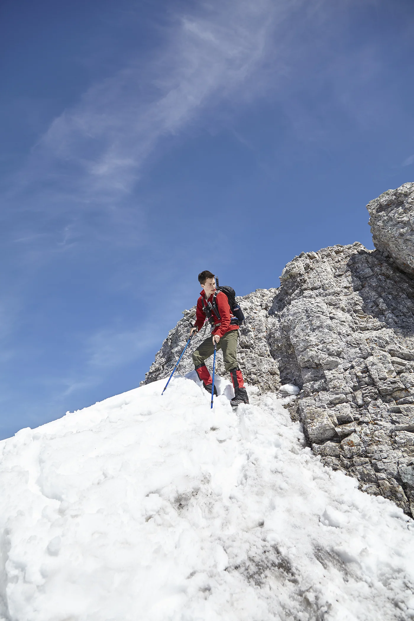 Yuri carefully descends the crux just under the summit ridge.