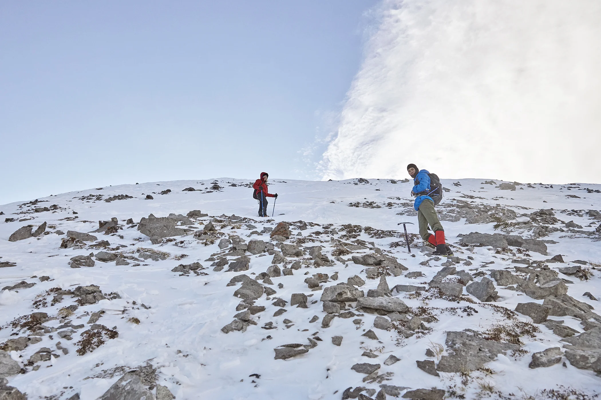 Yuri and Mindy ascend the last portion of snow and talus to the summit.