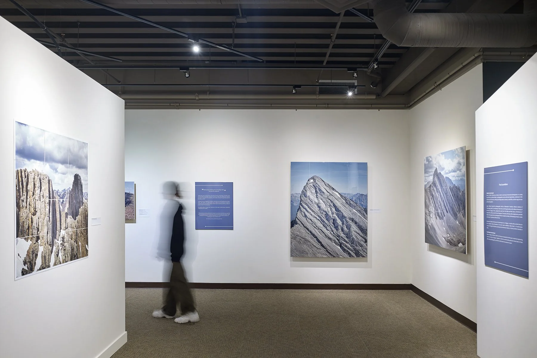   UPHIGH , Canmore Museum, 2024. Centre image:  Wind Mountain , 2021. 48” x 60”, tiled photographs on hardboard with epoxy resin. 