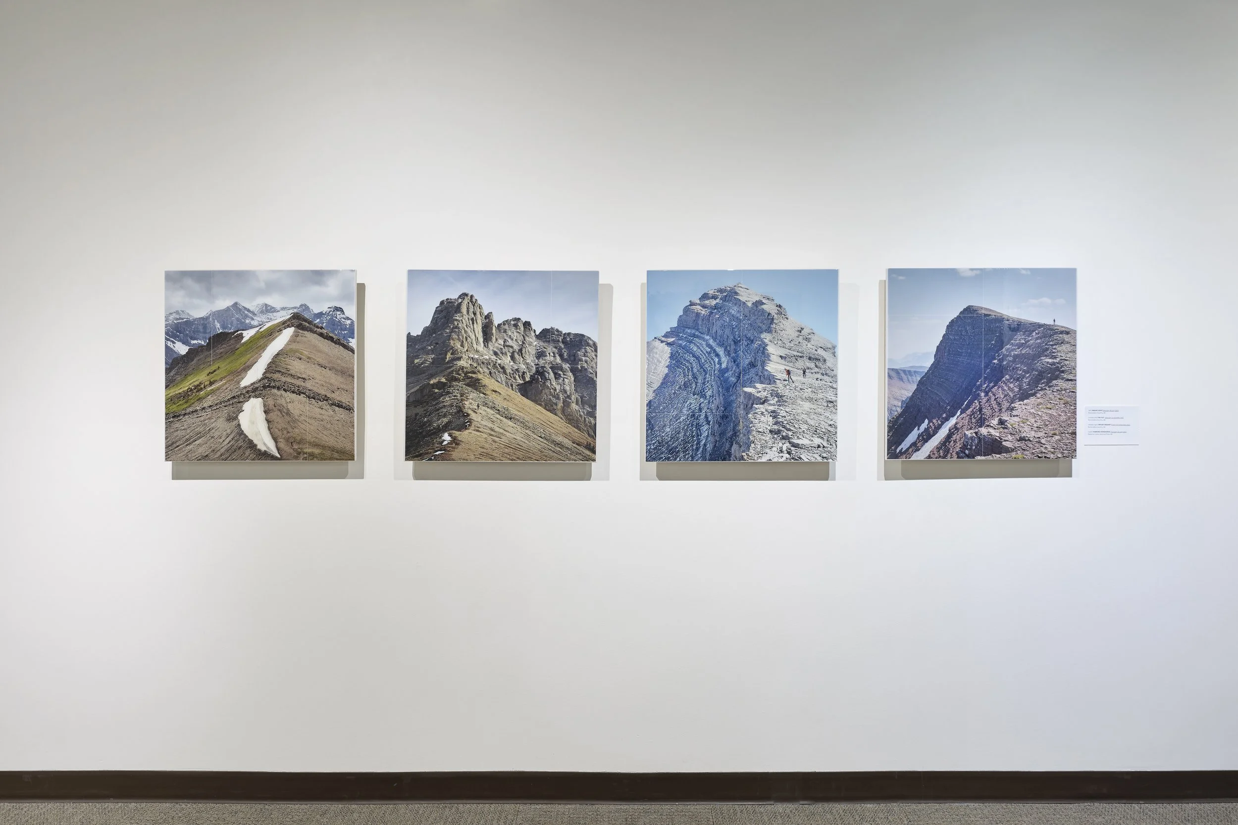   UPHIGH , Canmore Museum, 2024. 4 - 24” x 24”, tiled photographs on hardboard with epoxy resin. 