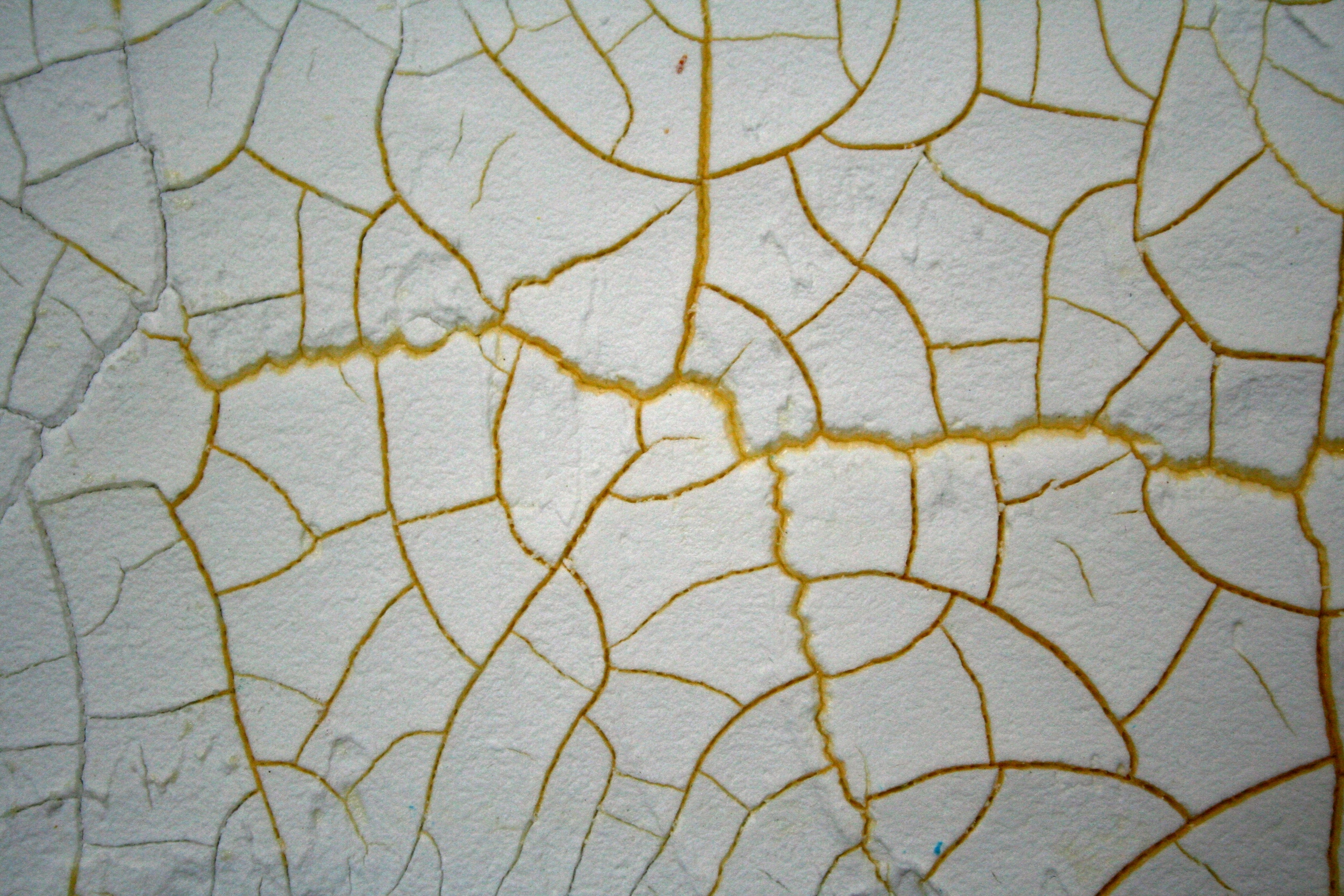 On the above panel the crackle paste has been spread out using a palette knife. The thickness is about that of a coin. The panel background was painted yellow to highlight the cracked areas. Generally the thicker the product the larger the cracks and the thinner the paste the smaller the cracks. You can use a variety of tools to apply the product to a number of different surfaces, a rigid surface is the best.