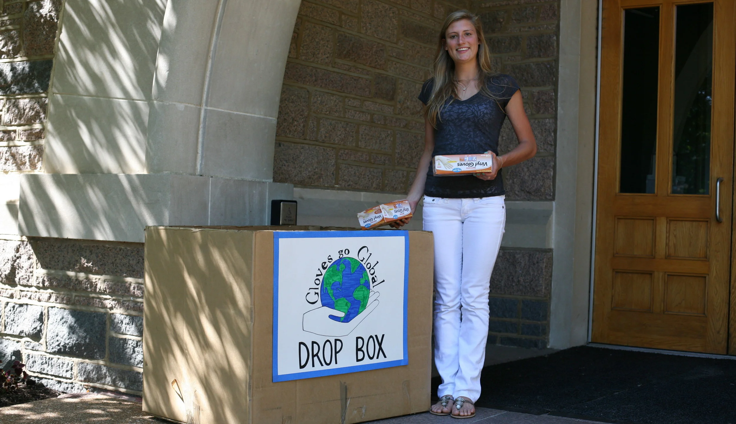 Hannah collects gloves from a drop box outside of the biology building at Washington University in St. Louis
