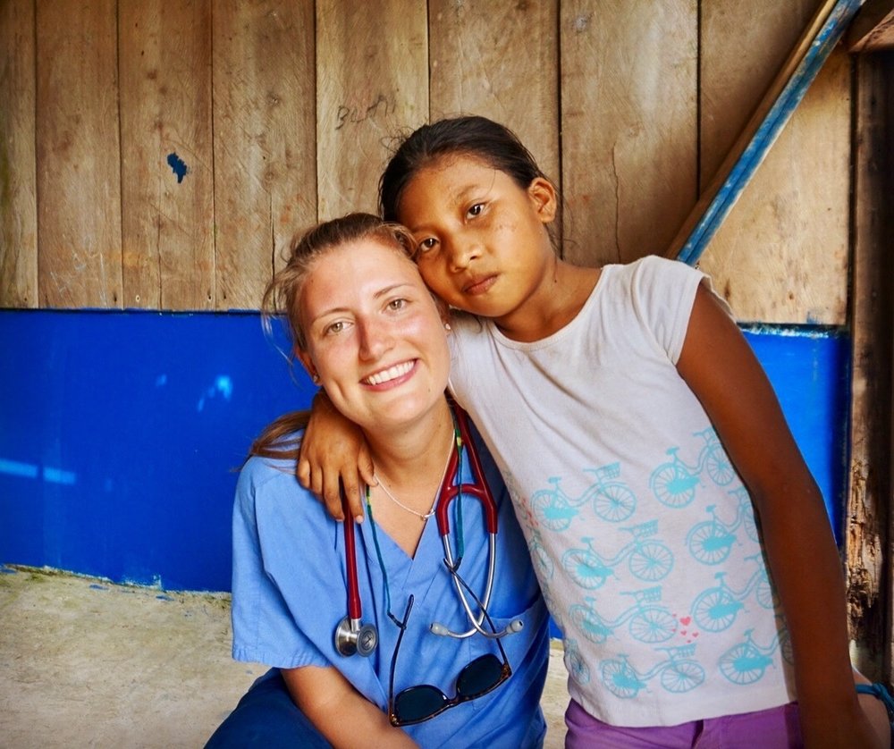  Hannah Akre with a young patient after clinic at Ensenada.&nbsp; 