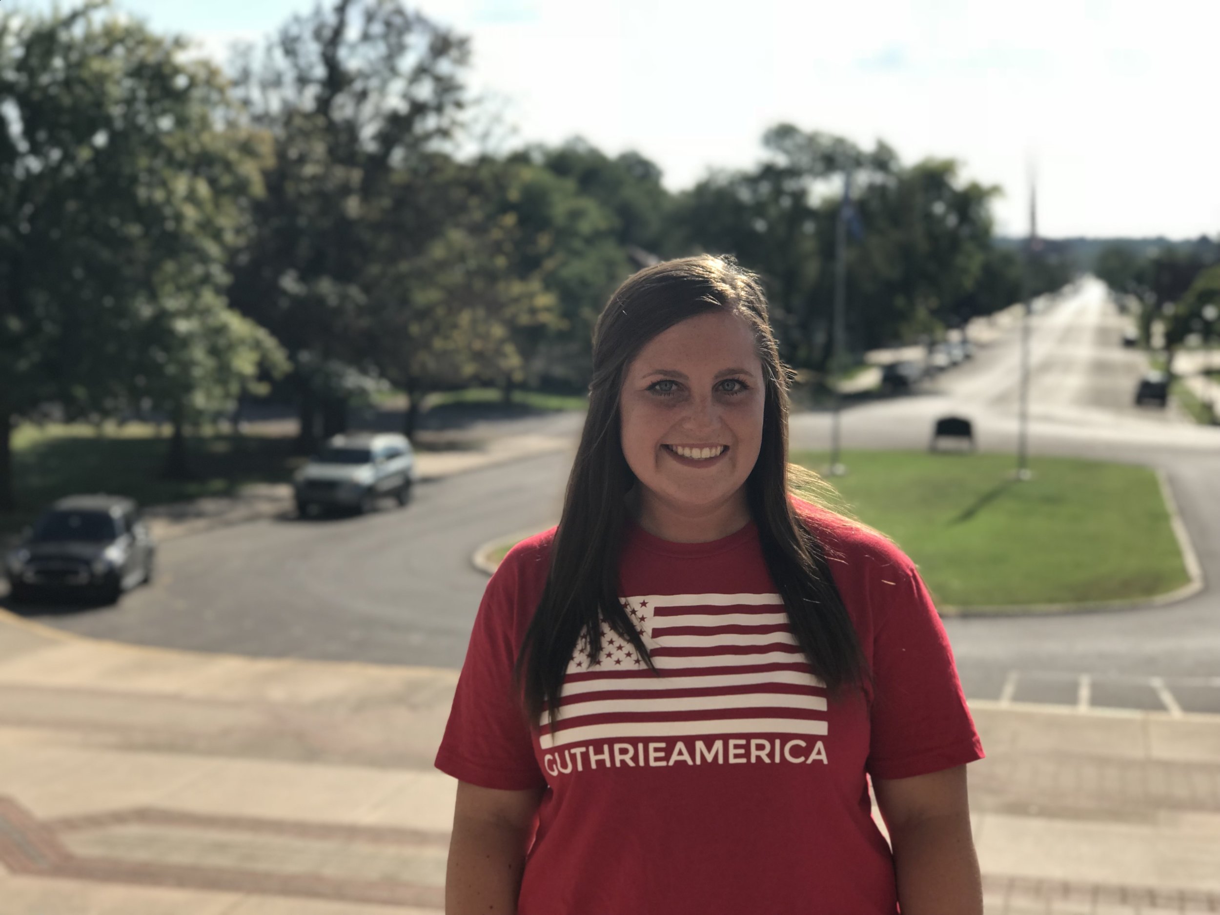 mollie with down town guthrie behind  her in guthrie america tee shirt.jpg