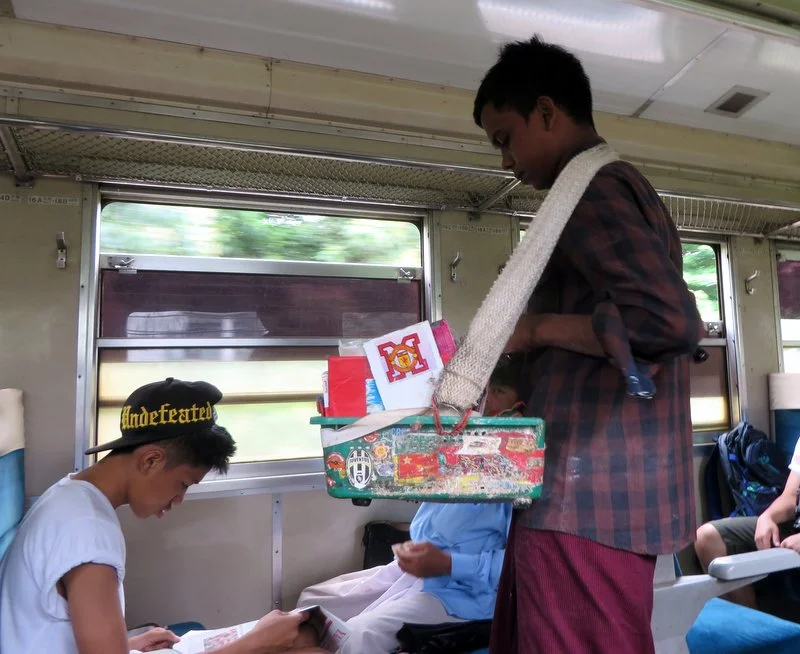 Vendor on the train selling Betel quid chewing tobacco. Iain declined to try it! 