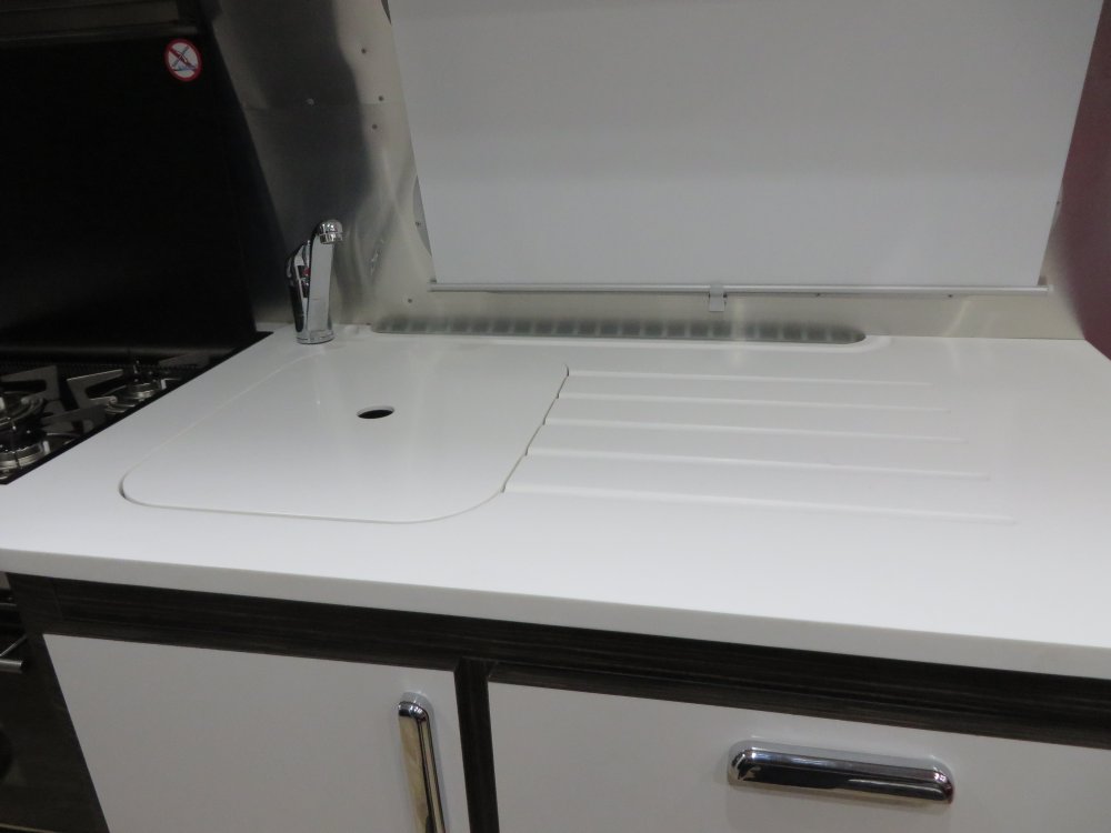A close up of the modern white Corian counter tops