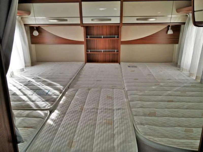 Large twin beds in the rear give maximum storage but still allow sleeping longitudinally. 