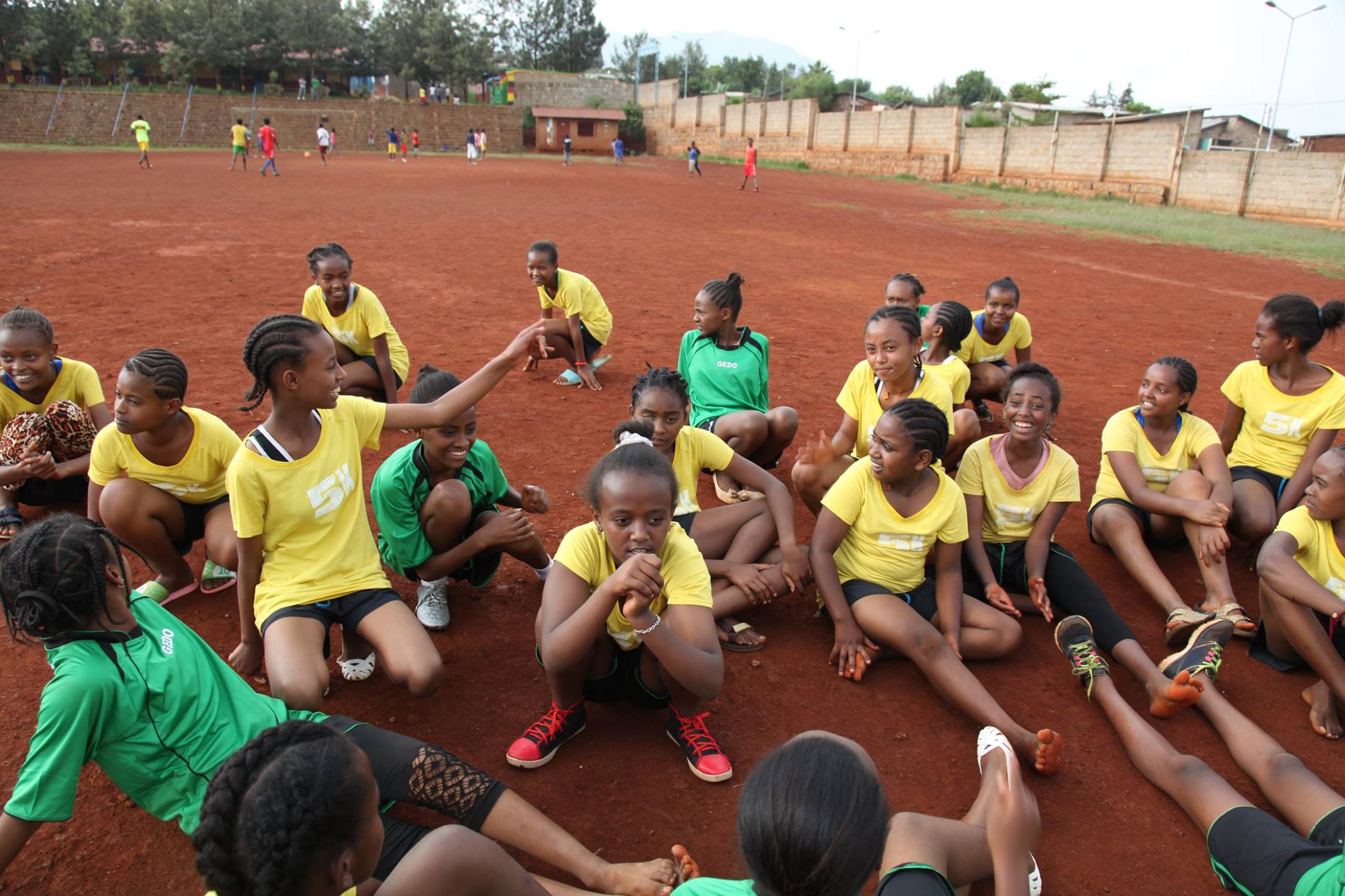 Girls get ready to stretch out after practice in Sodo, Ethiopia.