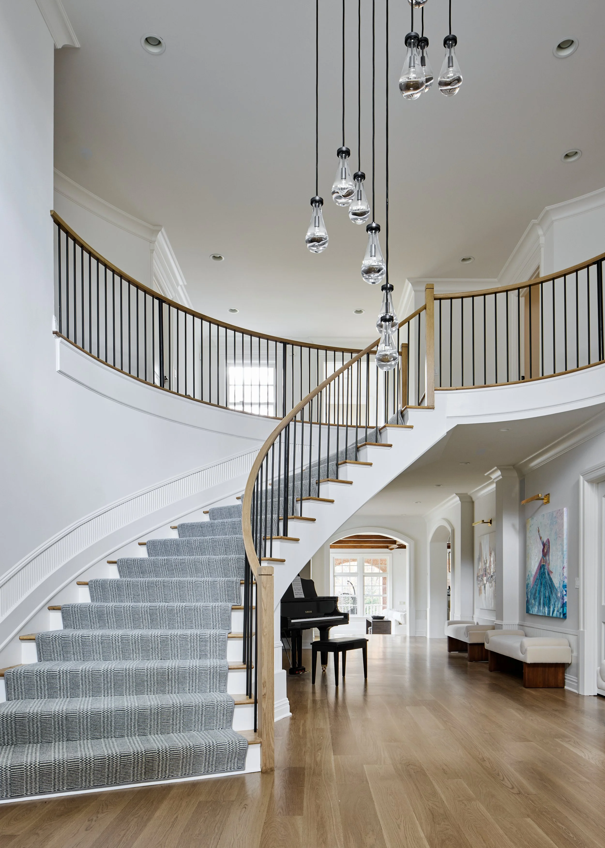 Foyer with grand staircase and piano in luxury Summit NJ renovation.jpg